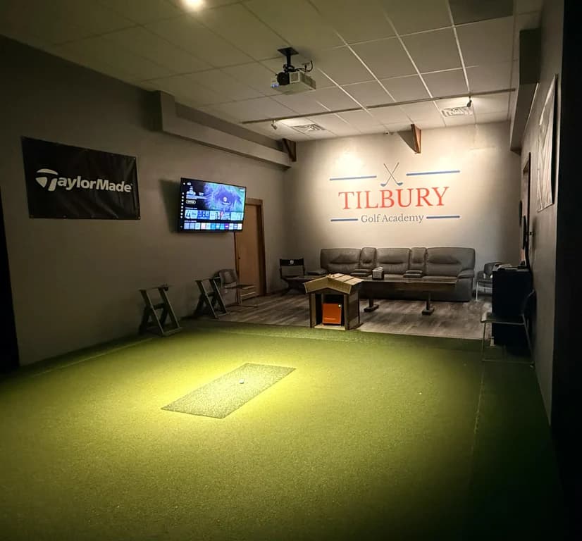 The Private Suite hitting area with a lounge sofa under the Tilbury logo wall
