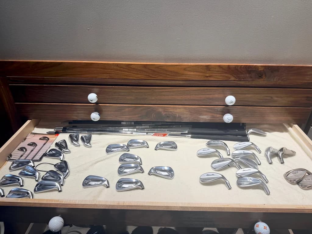 A fitting drawer laid out with iron and wedge heads and demo shafts